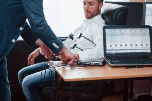 man connected to a polygraph machine