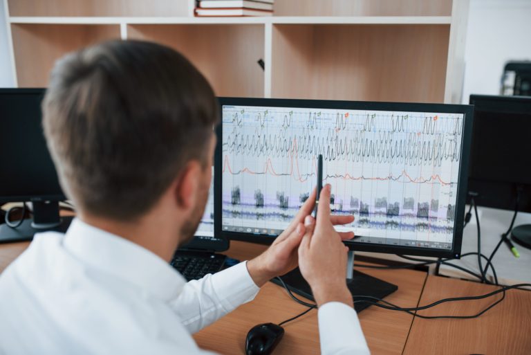 man viewing polygraph machine results